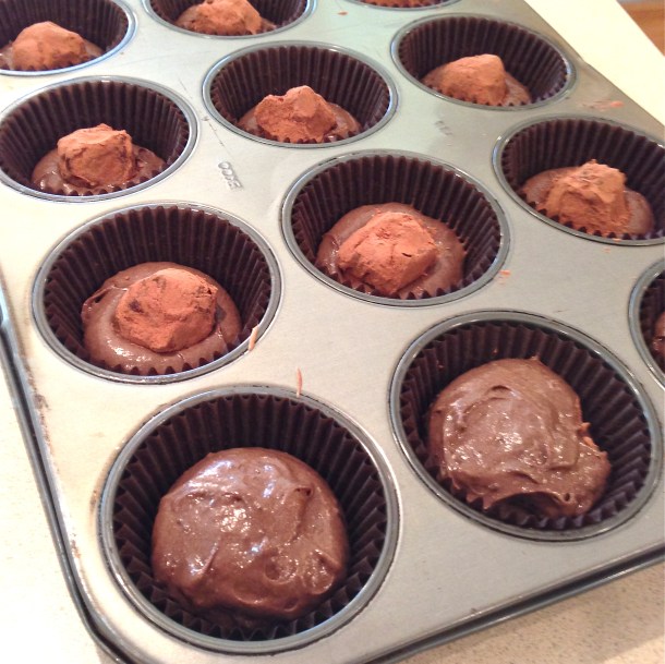 Press balls of cocoa-covered ganache into each cupcake...