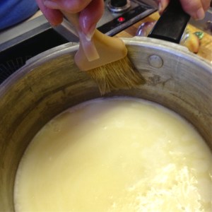 Use a pastry brush to brush water down sides of pan