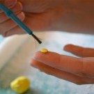 Use a little water on the fondant flower center