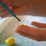 Use a little water on the fondant flower center