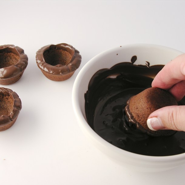 Dipping tops of cookie cups in chocolate